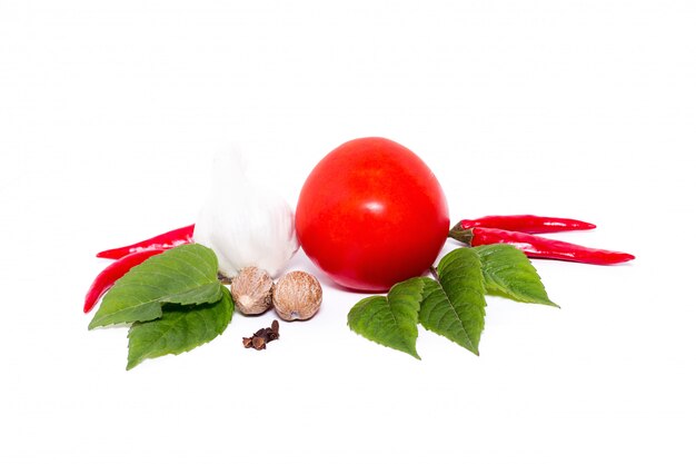 Tomato with pepper and garlic on white background ,composition of tomatoes and spices  top view