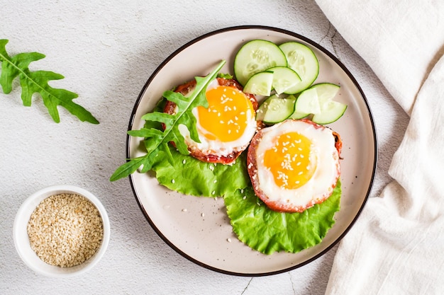 Tomatoes baked with egg and greens on a plate on the table Homemade lunch Top view