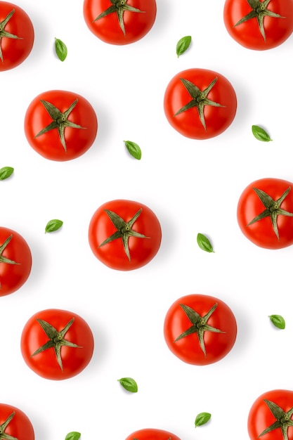 Tomatoes and basil leaves vertical pattern isolated on white background