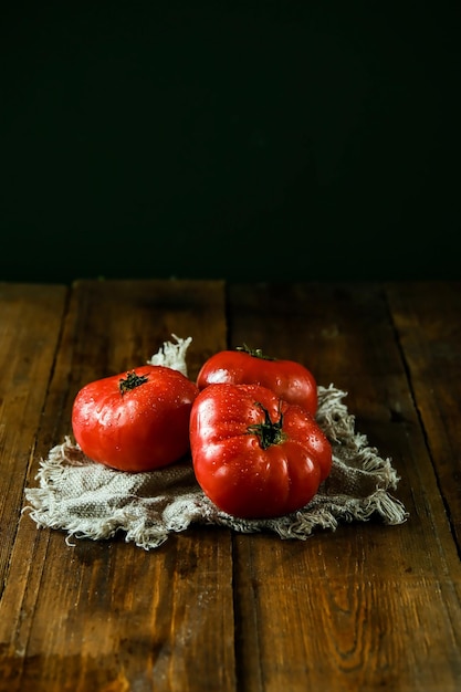 Tomatoes on a branch Fresh tomatoes on a wooden table Azeybarjan tomatoes Ripe tomatoes