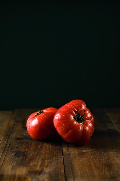 Tomatoes on a branch Fresh tomatoes on a wooden table Azeybarjan tomatoes Ripe tomatoes