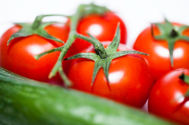 tomatoes and cucumbers on white background