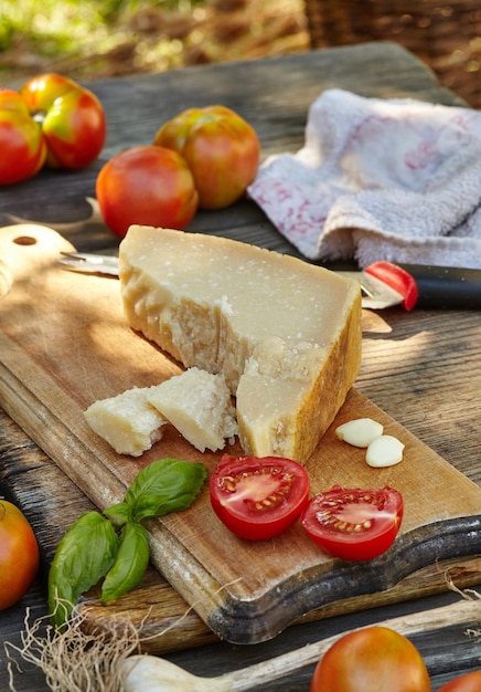 Tomatoes garlic basil and cheese parmigiano on an old authentic table