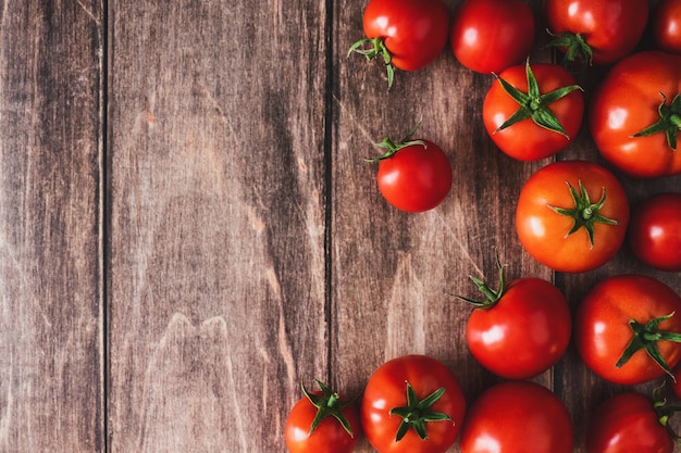 Tomatoes on old wooden table fresh red tomato vegetables flat lay with copy space