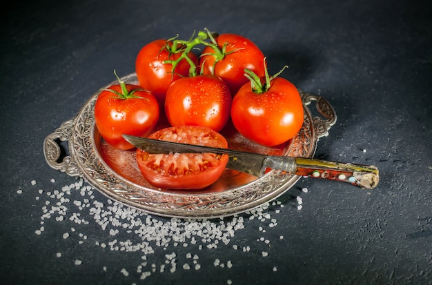 Tomatoes and salt. Low-key lighting