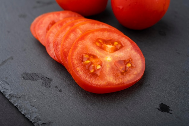 Tomatoes on the table. Finely chopped tomato slices