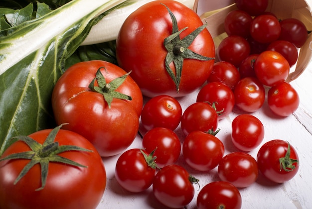 Tomatoes on white wooden eves