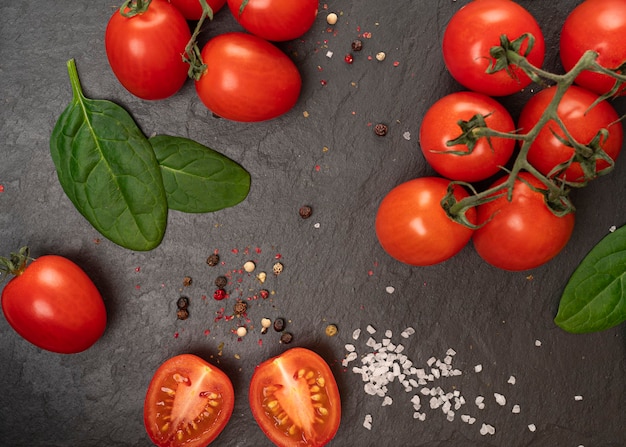 tomatoes with spinach and spices on the board in a cut and whole