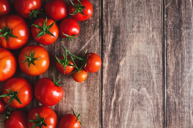 Tomatoes on wooden background freshly picked red tomato fruit frame cooking background copy space