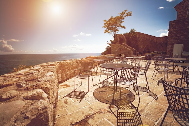 Toned photo of old restaurant summer terrace at sunny day