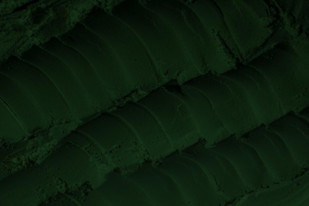 Toned rough surface of an old stone wall Closeup Dark emerald green color Background Solid