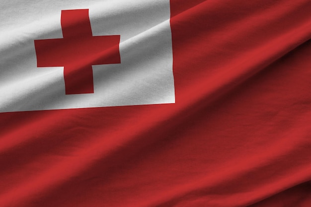 Tonga flag with big folds waving close up under the studio light indoors the official symbols and co