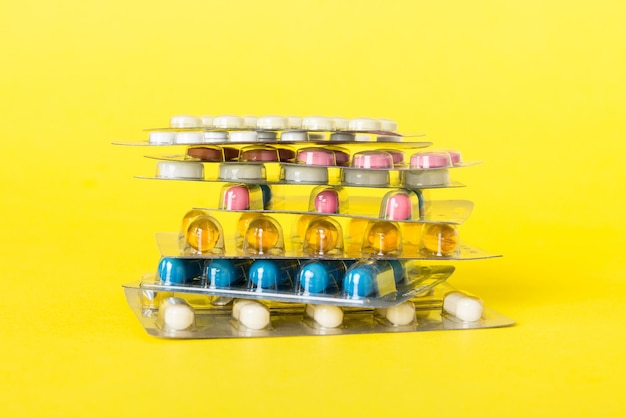 Too many different pill cartridges stacked selective Focus Packs of blister pills with tablets Colored pastilles packages A pile of medicine in blister packs Pharmaceutical blister packs