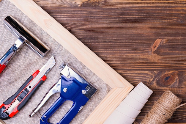 A tool for stretching a canvas with a photo on a wooden stretcher Stapler for staples forceps and a stationery knife