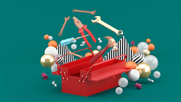 Toolbox amidst colorful balls on green. 3d rendering.