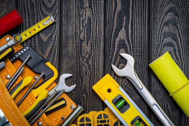 Tools in the bag for carpentry and accessories on wooden black boards