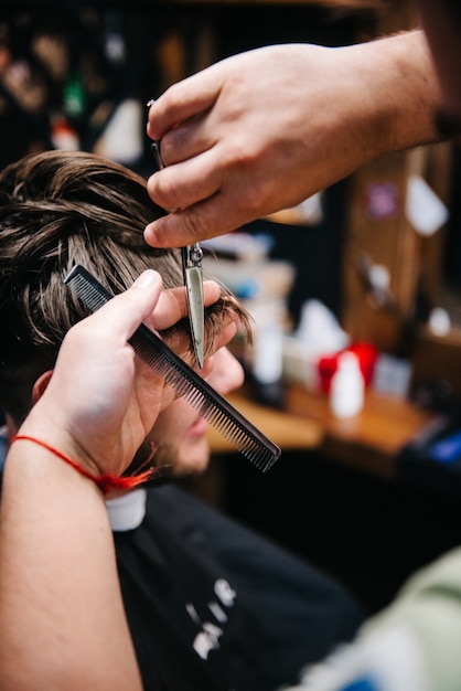 The tools of a Barber on the desktop in front of the mirror