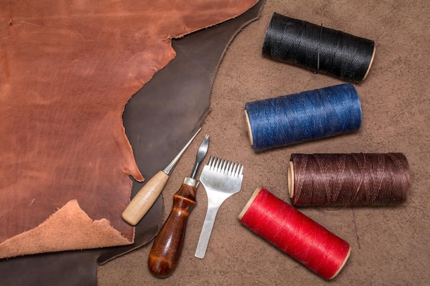 Tools for leather crafting and pieces of brown leather Manufacture of goods