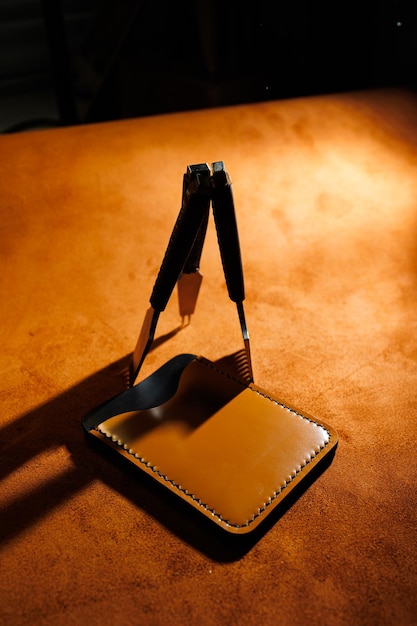 Tools for making leather goods and pieces of brown leather Production of leather products View from above