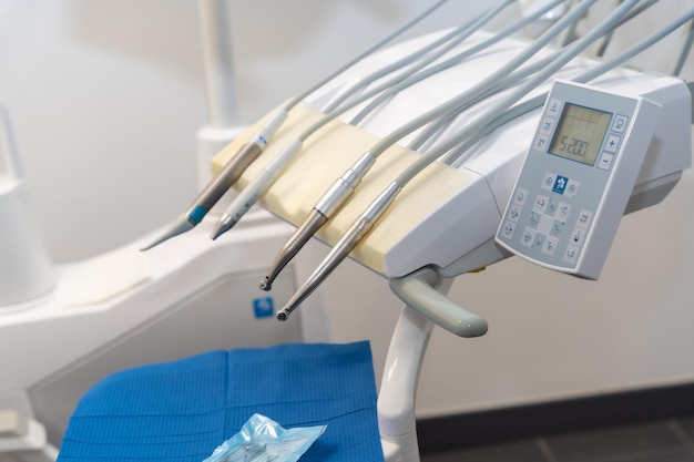 Tools used by doctors in a modern dental clinic next to the chair for operations