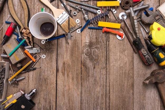 Tools of the worker on a wooden background