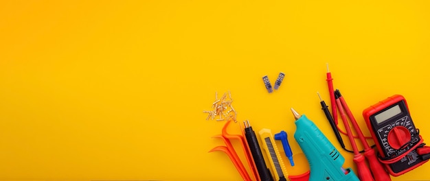 Tools on a yellow background screwdriver tester tracker