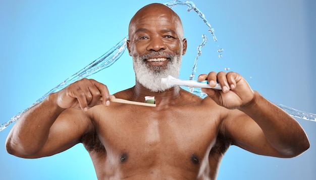 Toothbrush bamboo and black man in studio with toothpaste water splash and portrait for dental mouth and wood product promotion Senior model face brushing teeth and eco friendly marketing mockup