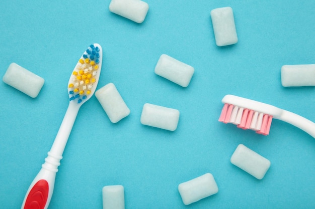 Toothbrush and chewing gums on a pastel blue background Minimal concept