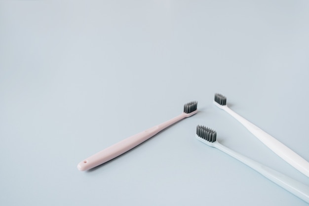 Toothbrushes on blue background. Oral care, dental hygiene concept.