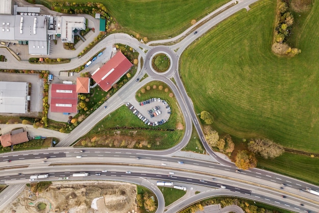 Top down aerial view of freeway interstate road with moving traffic cars in rural area.