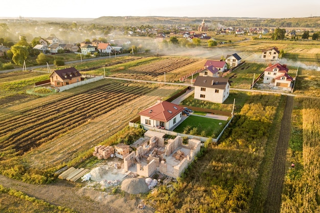 Top down aerial view of two private houses one under construction