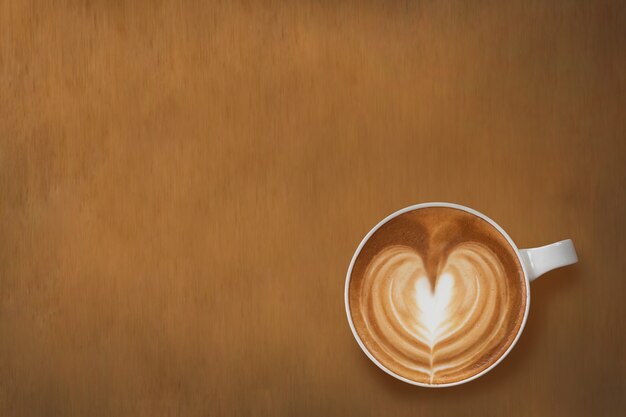 Top down view white cup of heart latte art coffee place on wooden table with copy space for text