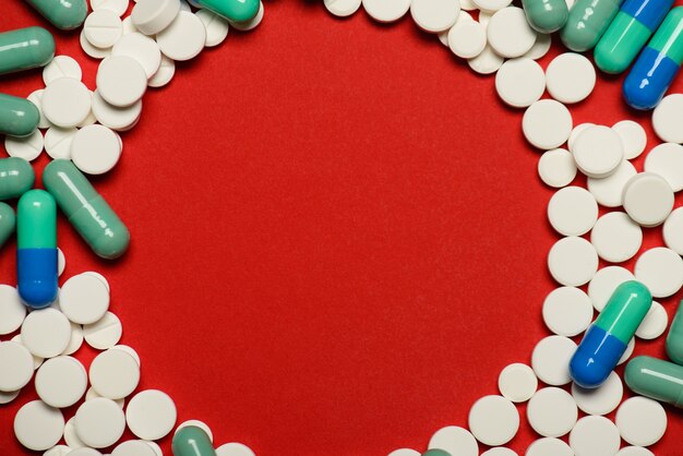 Top above overhead flatlay photo of many lot heap of pills and empty place in center