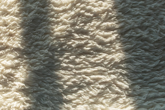 Photo top view abstract background of white fluffy carpet with shadows