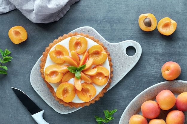 Top view of apricot tart with mint leaf