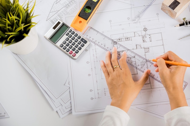 Top view of architect drawing with ruler on house plan blueprint paper for repair tools