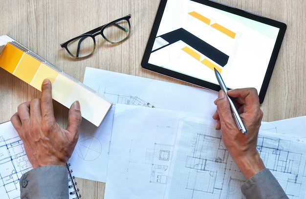 A top view of architect working desk with hand writing and draw on equipment