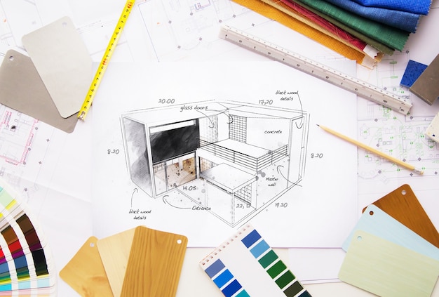 Top view of architectural workspace project surrounded by tools and materials