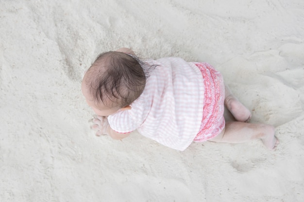 Top View of Asian Baby Crawling on the Sand