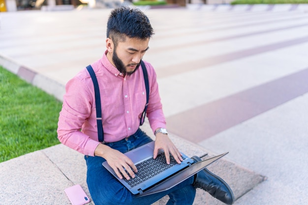 Top view of an asian man using a laptop