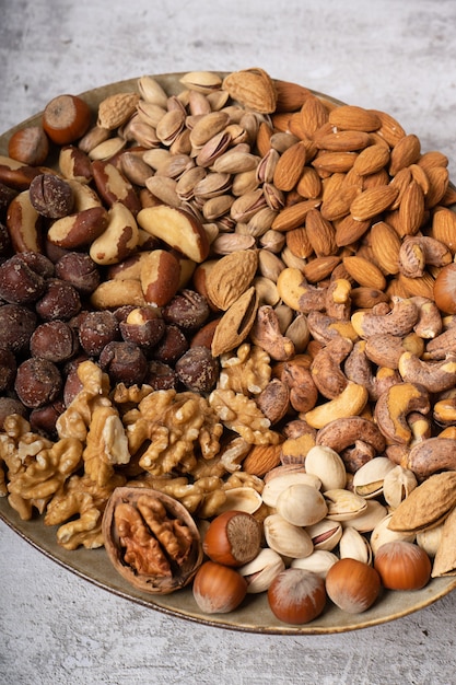 Top view of assorted different types of nuts on a plate.