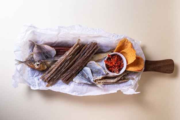 Top view of assorted dry fish for beer fish on a wooden board