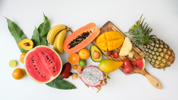 Top view of assortment of exotic fruits and leaves