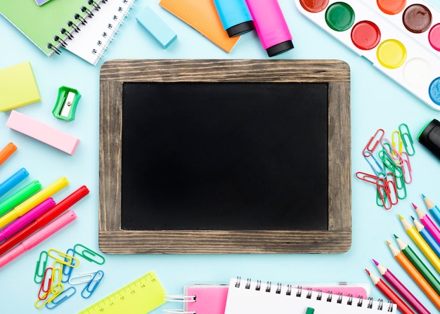 Top view of back to school stationery with blackboard