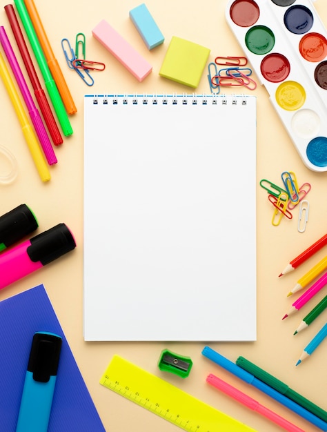 Top view of back to school stationery with pencils and notebook