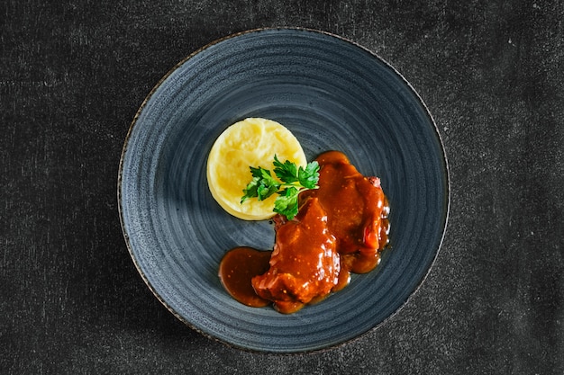 Top view of baked beef fillet with flour sauce with mashed potato