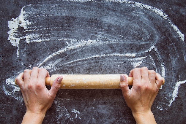 Photo top view baker setting flour on a board