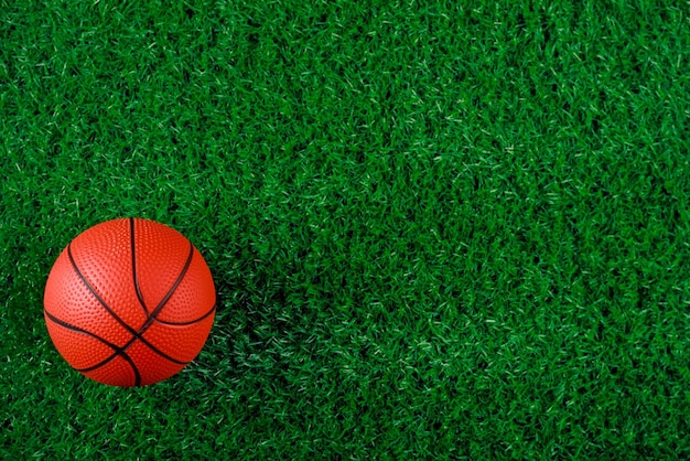 Top view of basketball ball on green background