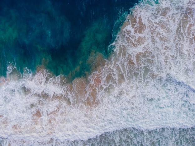 (Top view) Beach seawater wave on sandy beach. Background and travel concept.