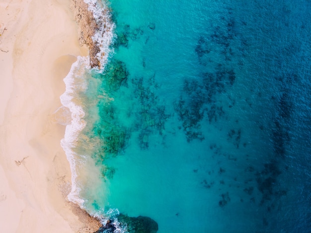 Top view of beautiful beach with clear turquoise water.